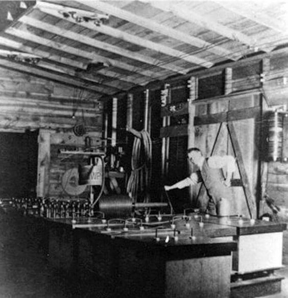 Interior of the Experimental Station, with an assistant at the switchboard