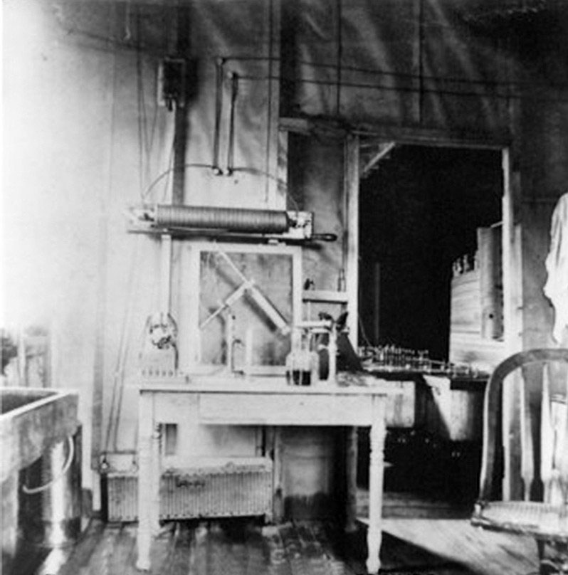 Interior of the Experimental Station, with a worktable of instruments and a doorway into the main room